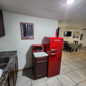 an old red refrigerator in a kitchen with a table at The Getaway in Three Rivers