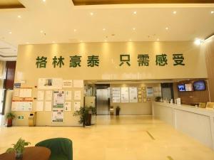 a lobby of a building with writing on the wall at GreenTree Inn Anqing Yingbin Dong Road High-Speed Railway Station in Anqing