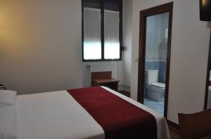 Ein Bett oder Betten in einem Zimmer der Unterkunft Pension Alameda