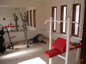 a room with a gym with a red chair and exercising equipment at Paseo de la Fe in Salta