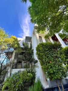 a white building with plants on the side of it at Stay199 in Haragama +15 photos