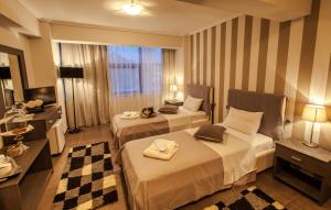 Postel nebo postele na pokoji v ubytování Aqua Mare Sea Side Rooms