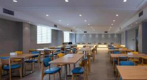 a dining room with tables and blue chairs at Vienna Hotel Guangdong Foshan Yihuanlishui in Foshan +21 photos