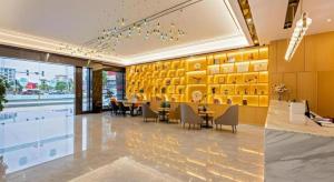 a dining room with tables and chairs in a building at Green Tree Inn Zhuhai International Airport Huafa Shangdu in Zhuhai