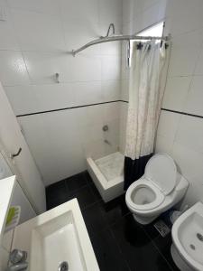 a small bathroom with a toilet and a sink at Check and Home - Peatonal II - 6 Huéspedes en el Centro a 3 cuadras de la Playa in Mar del Plata +3 photos