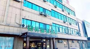a building with a sign on the front of it at GreenTree Inn Express Jinan Zhangqiu Districty Ancinet Town Longquan Road in Jinan +49 photos