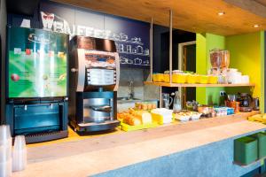 a kitchen with a counter with a stove and food at ibis budget Granville in Granville +59 photos