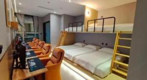 a bedroom with two bunk beds and chairs at Shenzhen Nan Fei Yuan Hotel in Shenzhen +60 photos