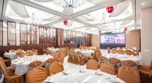 a banquet hall with white tables and chairs at Borrman Hotel Changzhi Medical College Wulong Campus High-speed Railway South Station in Changzhi