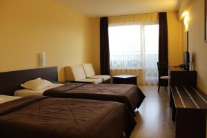 Postel nebo postele na pokoji v ubytování Hotel Arena