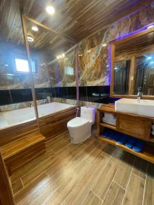 a bathroom with a tub and a toilet and a sink at KND Wind Valley Bình Thuận in Xóm Chum Găng +72 photos