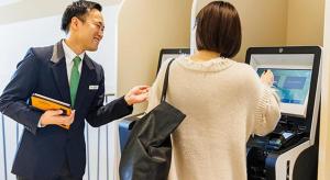 a man standing next to a woman in front of a cash register at Hotel Dream Gate Maihama in Chiba