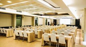 a room with tables and white chairs and a screen at River Kwai Village Hotel in Ban Kaeng Raboet +225 photos