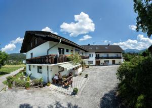 an aerial view of a house with people sitting outside at Pension Stausee in Sankt Jakob im Rosental