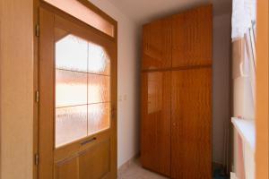 a hallway with a wooden door and a window at Apartment Andre in Uherské Hradiště