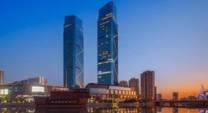 two tall skyscrapers in a city at dusk at Dongwu New Century Grand Hotel Huzhou in Huzhou