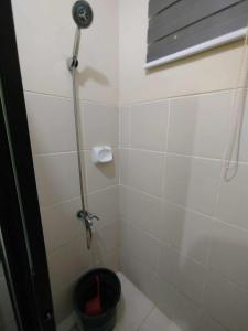 a bathroom with a shower with a bucket at Z Crib Solana in Bacolor +13 photos