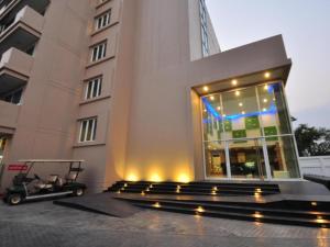 a building with a golf cart in front of it at Tanzeno Hotel in Nong Khai