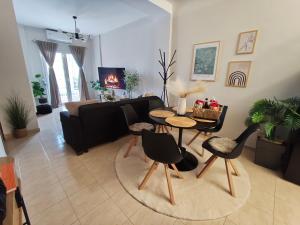 a living room with a couch and a table and chairs at Joanna Dalatsi's Luxury House in Alexandroupoli
