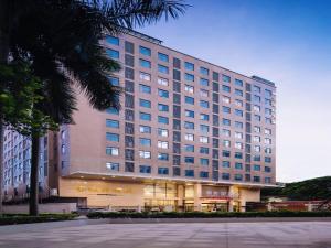 a large building with a store in front of it at T Social Hotel Guangzhou Railway Station Branch in Guangzhou