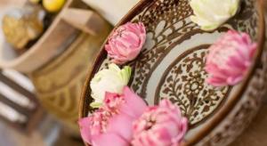 a bowl with pink flowers on the side of it at Wake Up at Muang Kao Boutique Hotel in Sukhothai