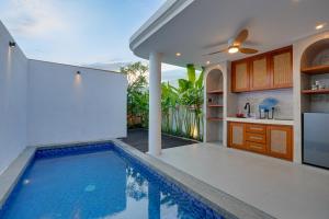 a kitchen and a swimming pool in a house at Elegant 1BR Villa Jasmine LaLuxe A11 Sanur in Sanur