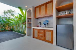 a kitchen with a stainless steel refrigerator and a deck at Elegant 1BR Villa Jasmine LaLuxe A11 Sanur in Sanur