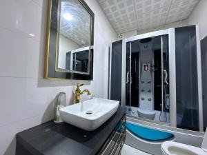 a bathroom with a sink and a mirror at Welcome to your home away from home! in Kabul