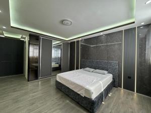 a bedroom with a large bed and a bathroom at Welcome to your home away from home! in Kabul