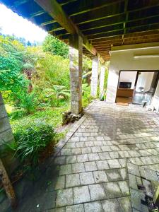 an outside view of a building with a patio at St Okes Apartment- Peaceful retreat set in native bush Stay 1 night, 1 week or 1 month in Lower Hutt
