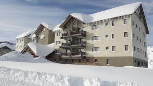 a building in the snow with snow around it at Valle Nevado Apartamento Ski In Out in Valle Nevado