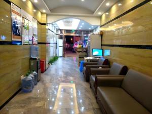 a lobby of a store with couches and a television at Shell Jiaxing Nanhu District Dongsheng Dong Road Moon River Street Hotel in Jiaxing +90 photos