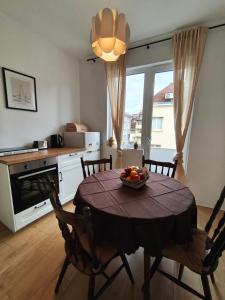 a kitchen with a table with a bowl of fruit on it at Serenity Lodge, next to NDK in Sofia +5 photos