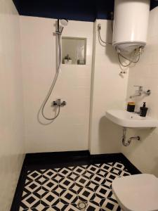 a bathroom with a toilet and a sink at Serenity Lodge, next to NDK in Sofia