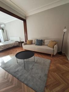 a living room with a couch and a table at Serenity Lodge, next to NDK in Sofia