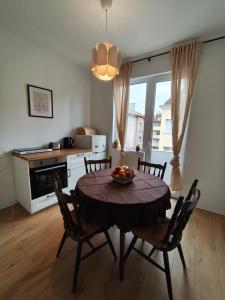 a kitchen with a table with a bowl of fruit on it at Serenity Lodge, next to NDK in Sofia