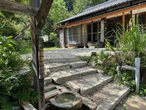 a set of stone steps in front of a house at ANBAEE Private Mountain Villa あんばええ in Nakatsugawa