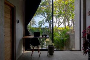 a room with a table with a laptop on it at Kalypso in Tanah Lot