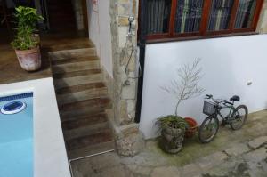 a bike parked next to a building with a staircase at Nuestra Casa in San Juan del Sur