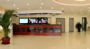 sala de estar con TV y pantalla grande en GreenTree Inn Tangshan Yuhua Road, en Fujiatun