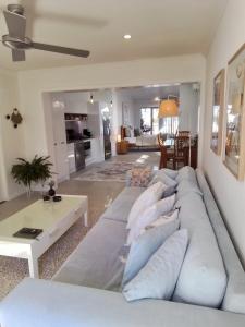 a large white couch in a living room at Studio 21 Waterfront in Yamba