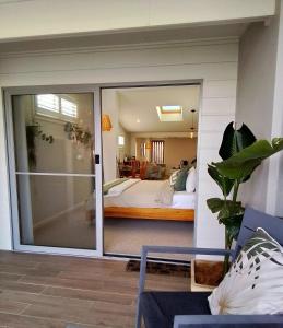 a room with a large sliding glass door leading to a bedroom at Studio 21 Waterfront in Yamba +20 photos