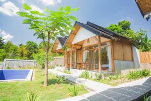 a house with a pool and a tree at Harmony hill in Bayan