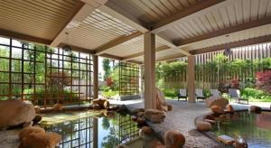 a large room with a pool of water with rocks at Fliport Hotel Zhangzhou Yuanshan in Zhangzhou