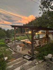 a wooden pavilion with a picnic table in a field at ANBAEE Private Mountain Villa あんばええ in Nakatsugawa +43 photos