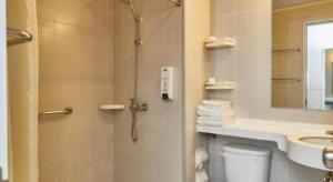 a bathroom with a shower and a toilet and a sink at Jinjiang Inn Shanghai Qingpu in Shanghai +87 photos