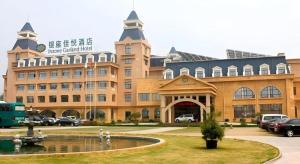 a large building with a fountain in front of it at Inzone Garland Hotel Taian in Huangqian