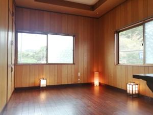 a room with two lights on the floor and two windows at Fujiya in Sango