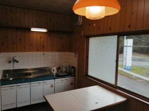 a kitchen with a counter and a sink and a window at Fujiya in Sango