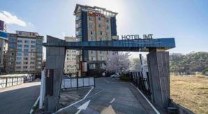 a sign for a hotel in front of a building at Nostalgia Hotel in Paju